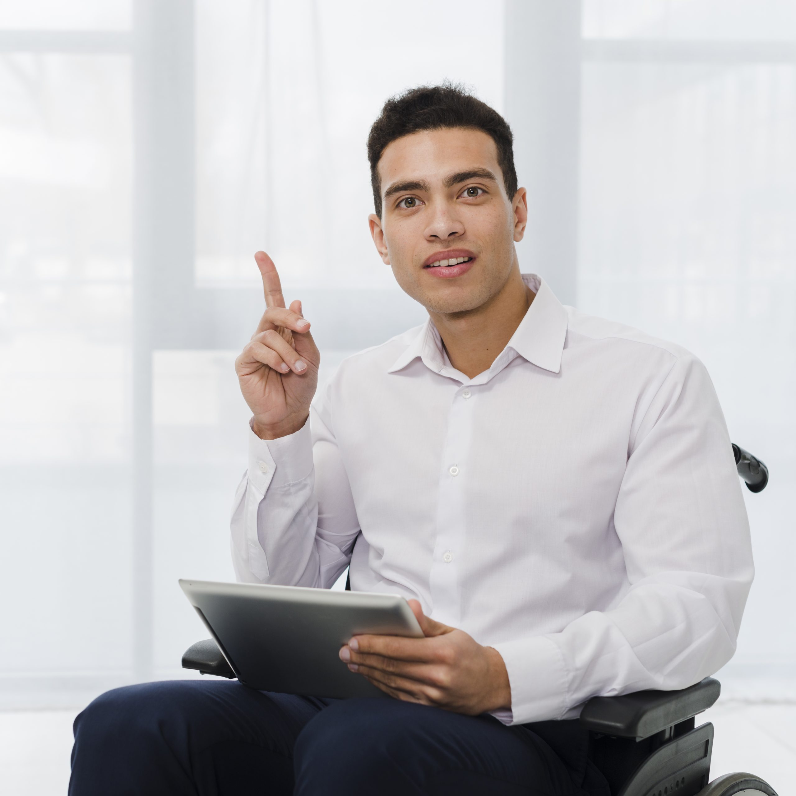 portrait-young-businessman-sitting-wheelchair-holding-digital-tablet-hand-pointing-his-finger-upward
